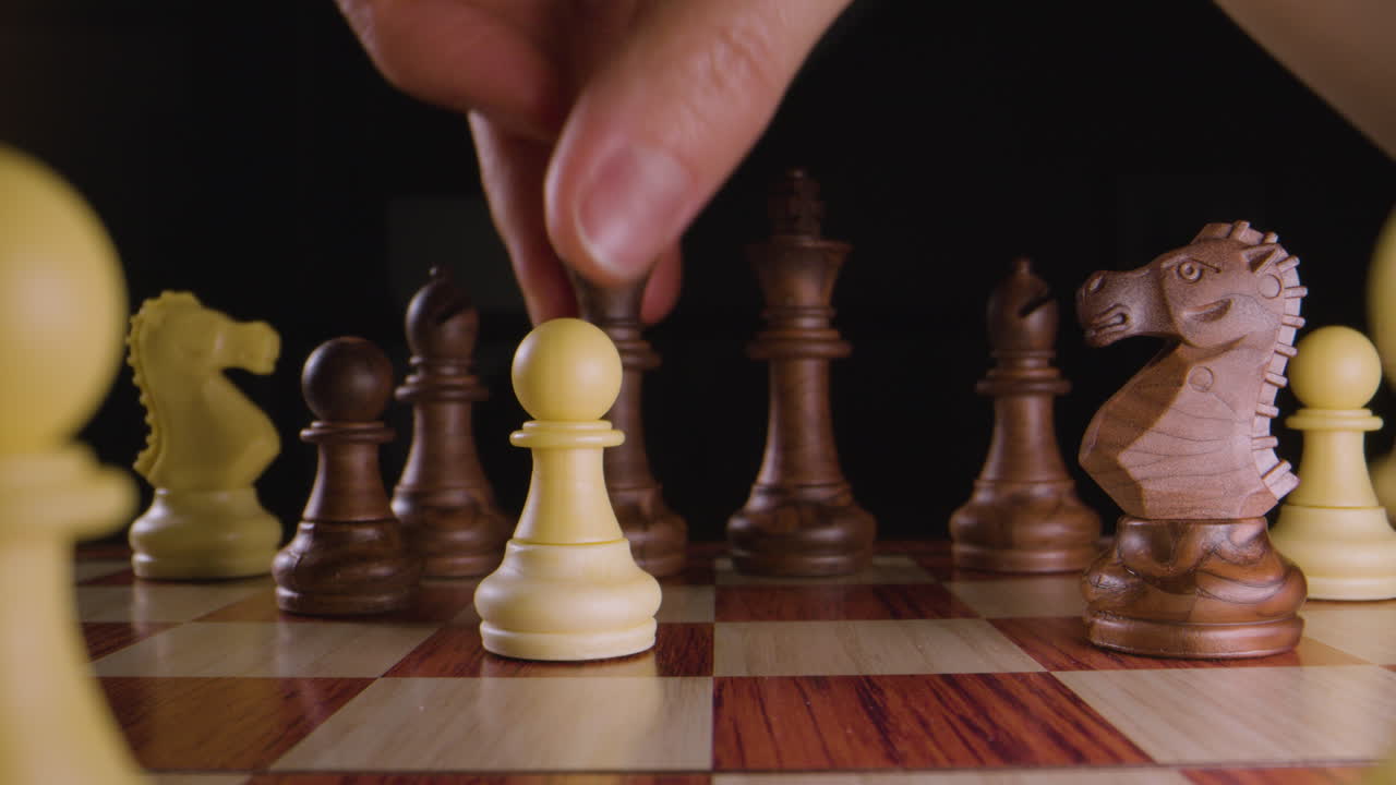 Chess board, queen takes pawn. Macro.