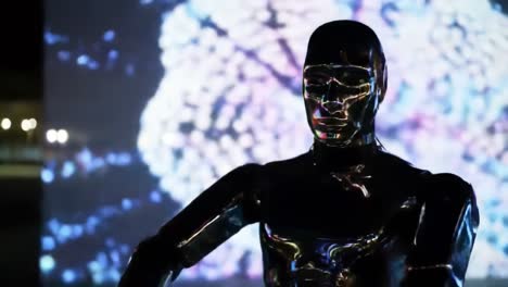 a sleek robotic figure stands confidently in an urban environment, illuminated by a colorful digital display. the fusion of technology and art captivates onlookers, creating an engaging atmosphere.