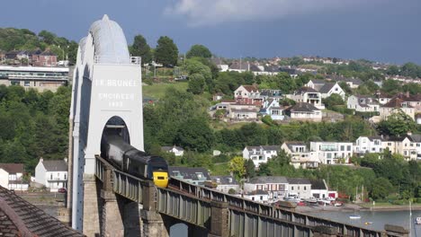 the royal albert bridge over the river tamar built by isambard kingdom brunel with a gwr train crossing over the bridge on a summer's day in england
