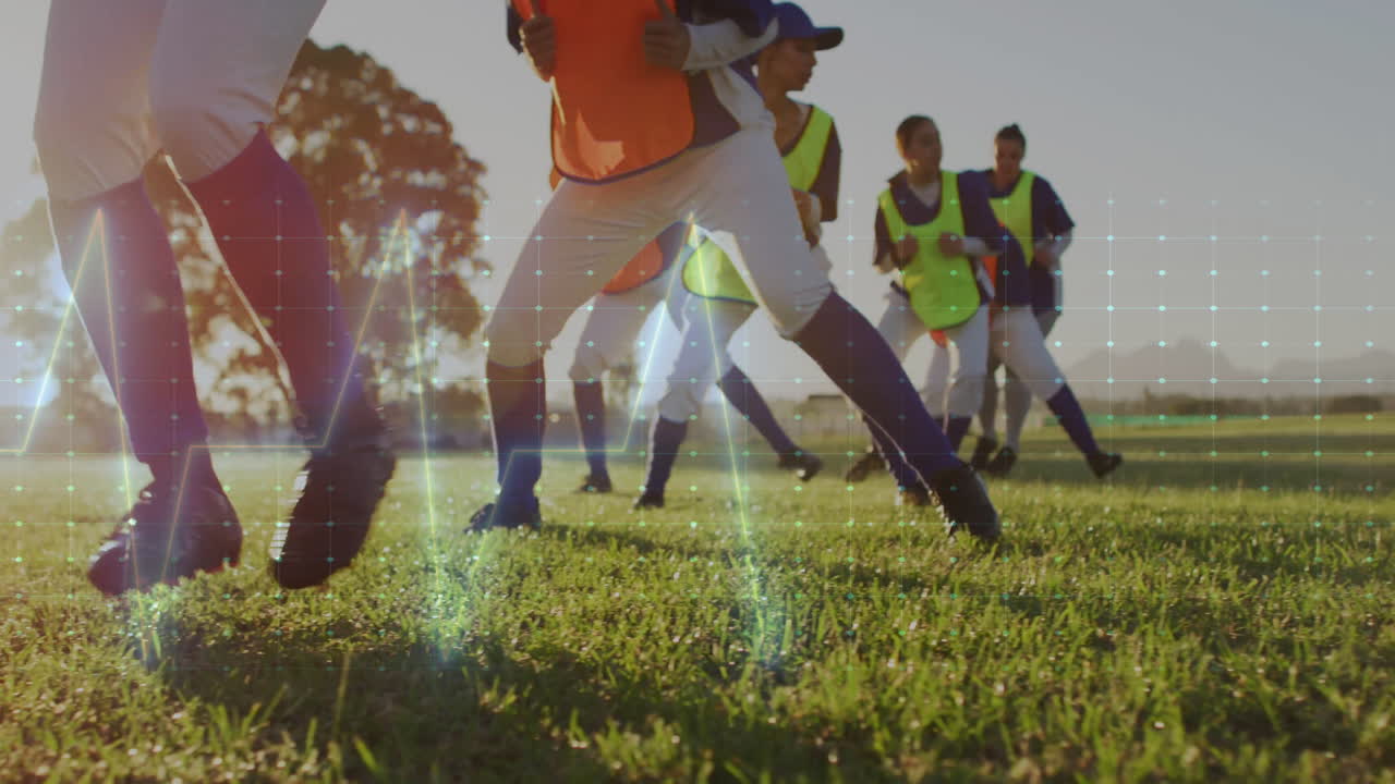 Young athletes playing soccer on grass field with digital data overlay animation