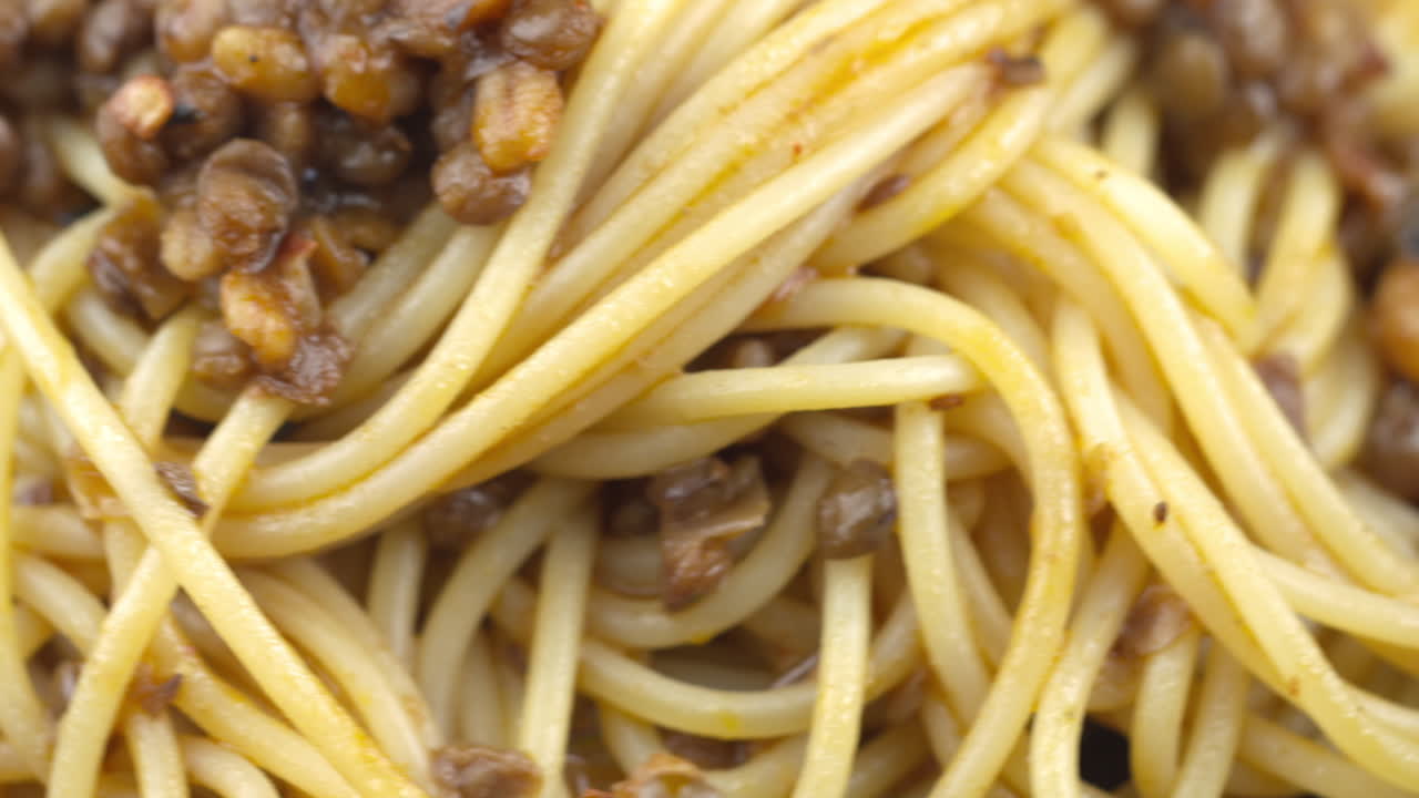 Close Up Of Lentil Pasta, Vegan Pasta, Vegan Spaghetti Dish, Close Up Of Spinning Bowl Of Vegetarian Pasta. Plant Based Mushroom And Lentil Meal