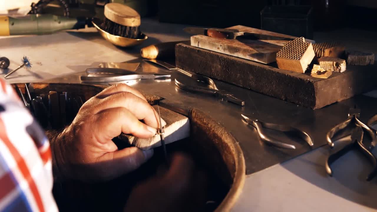 Goldsmith working in workshop