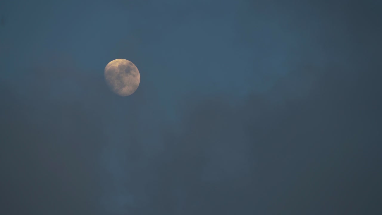 Clouds Slowly Cover Illuminated Waxing Gibbous Moon at Dusk