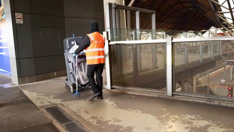 worker collects trash at melbourne station