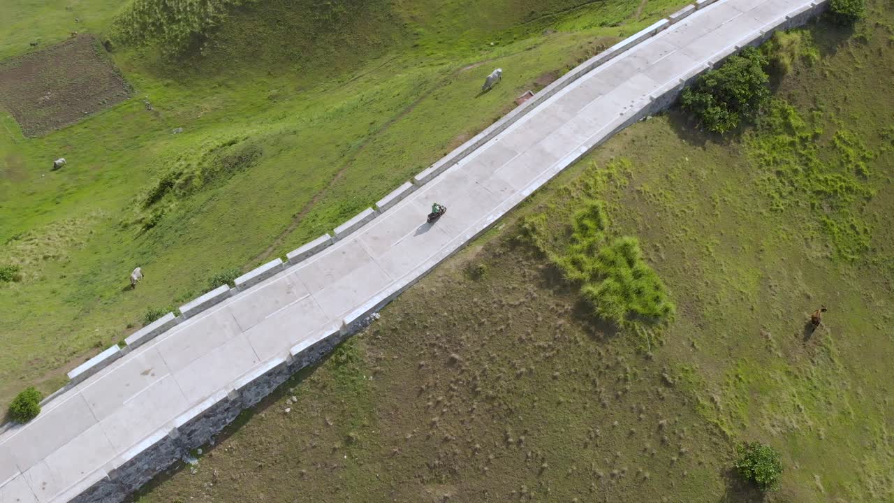 바타네스에서 스쿠터를 타는 남자의 스포트라이트 드론 샷