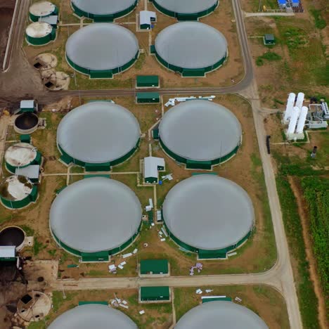 biogas production. modern territory with round reservoirs for renewable energy from biomass. bio gas complex on field. top aerial view.