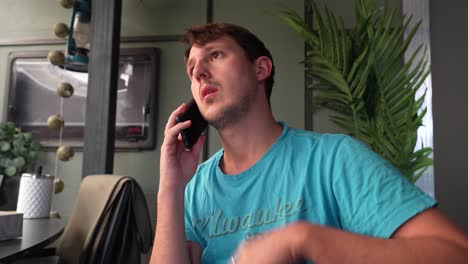 confused or surprised man in a phone conversation