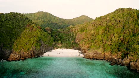 sunset drone shot of koh phi phi don and surrounding islands with nui beach and boats passing
