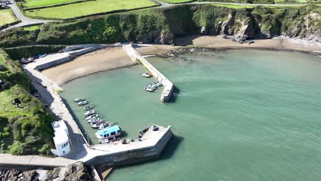 Aerial-coast-Ireland-sheltered-little-fishing-harbour-of-Boatstrand-Copper-Coast-Waterford