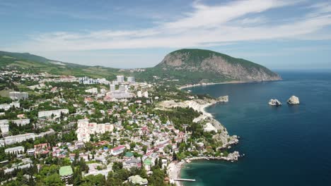 aerial panoramic view on gurzuf resort city and bear mountain, ayu-dag, yalta, crimea. spring sunny day. nature summer ocean sea beach background. vacation, travel and holiday concept