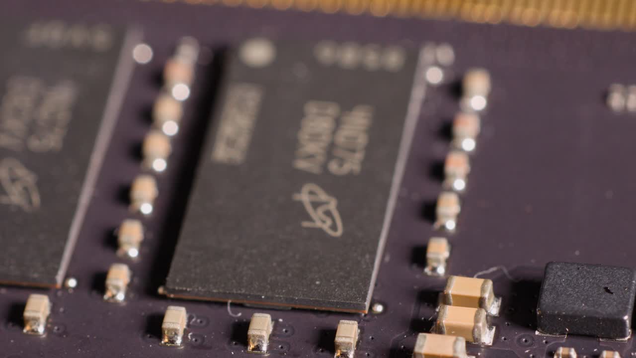 A slow macro camera pan across the integrated circuits and components of a RAM module