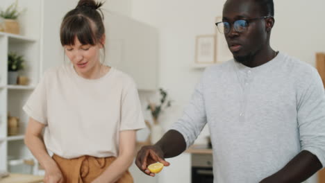 multiethnic couple cooking vegetable salad in kitchen