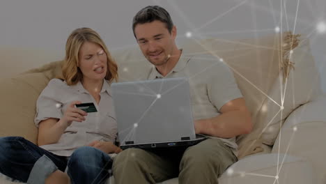 Animation-of-network-of-connections-over-caucasian-couple-using-laptop