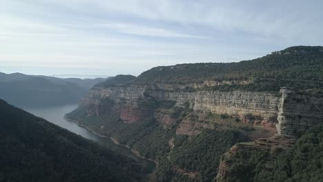 Morro-de-l'abella-river-aerial-view-following-breath-taking-winding-lush-canyon-foliage-cliff-viewpoint-Catalonia-Spain