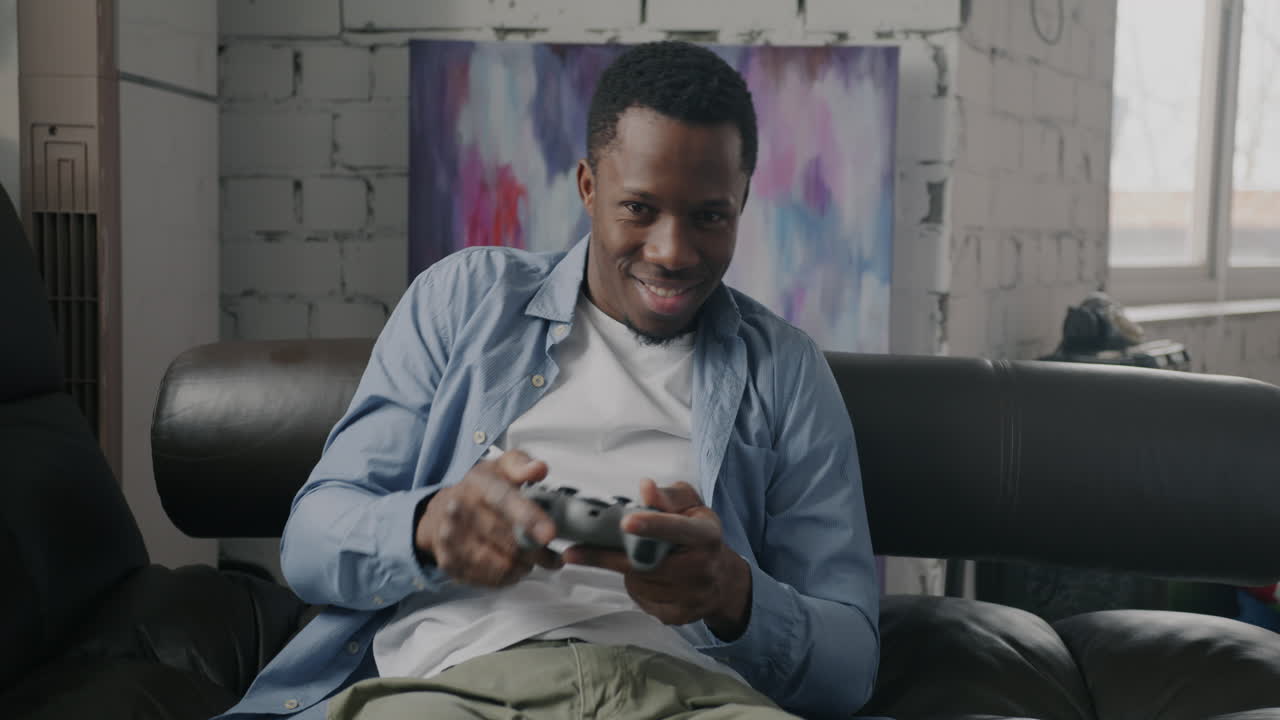 Man Playing Video Games on a Couch