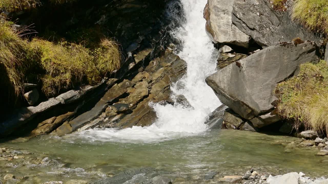 Small Stream Waterfall in Nepal in the Himalayas Mountains, Close Up River Flowing and Waterfall Scenery in Nepal Nature in High Altitude Terrain at Annapurna Base Camp