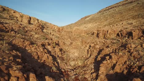 Aerial-shot-of-a-little-beach-and-rocks-formations-in-the-Partida-Island,-Archipielago-Espritu-Santo-National-Park,-Baja-California-Sur