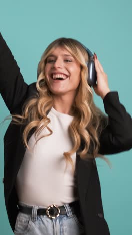 cheerful transgender businesswoman dancing while listening to music