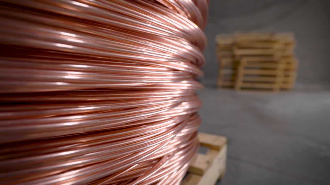 Copper rod. Thick copper wire coiled into a huge bobbin. Copper is one of the rare metals used everywhere