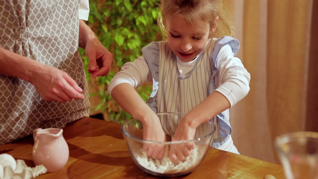 A mother and her young daughter baking together