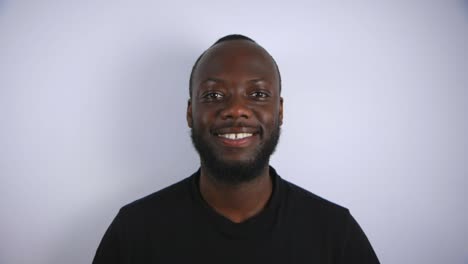 black male smiling into camera with white background