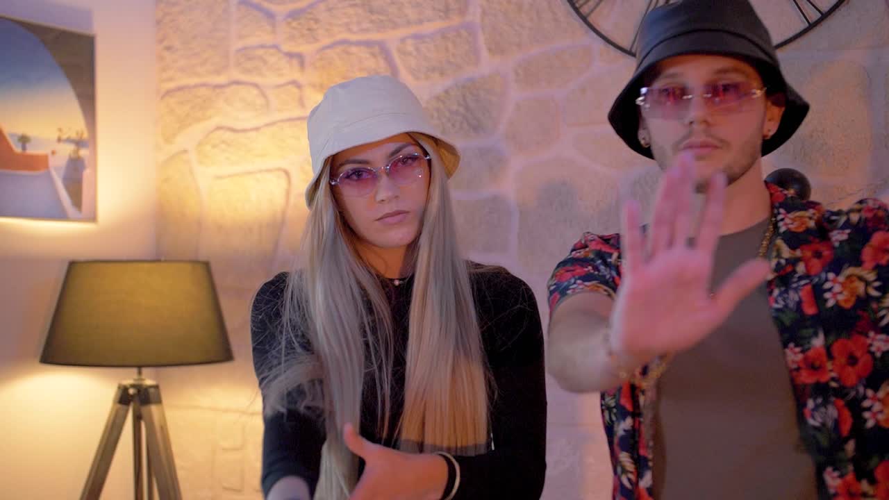 slow motion shot of a couple getting pressured with a gun being drawn