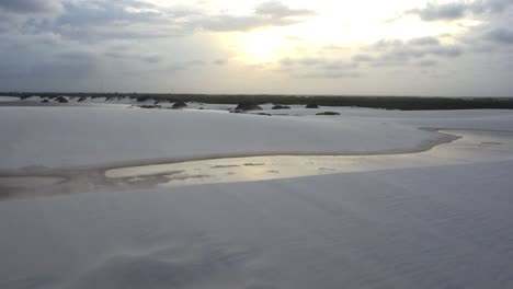 Aerial-view-of-dunes-and-rainwater-lakes-during-sunset-at-Lençóis-Maranhenses-National-Park,-Barreirinhas,-Maranhão,-Brazil-Northeast-Coast