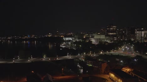 Slow-aerial-dolly-forward-toward-parliament-and-supreme-court-in-downtown-Ottawa-Canada-at-night,-the-capital-city-of-Canada