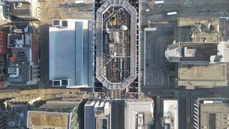 aerial drone flight giving a birdseye view over the rooftop of the city tower building in piccadilly gardens in manchester city centre