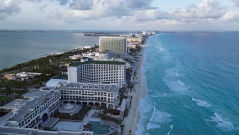 Evening-aerial-flight-over-sand-spit-hotel-zone-at-Cancun,-Mexico