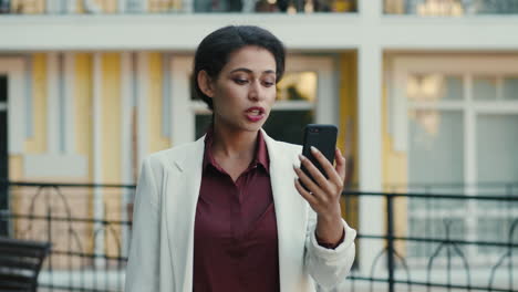serious business woman having video call outside