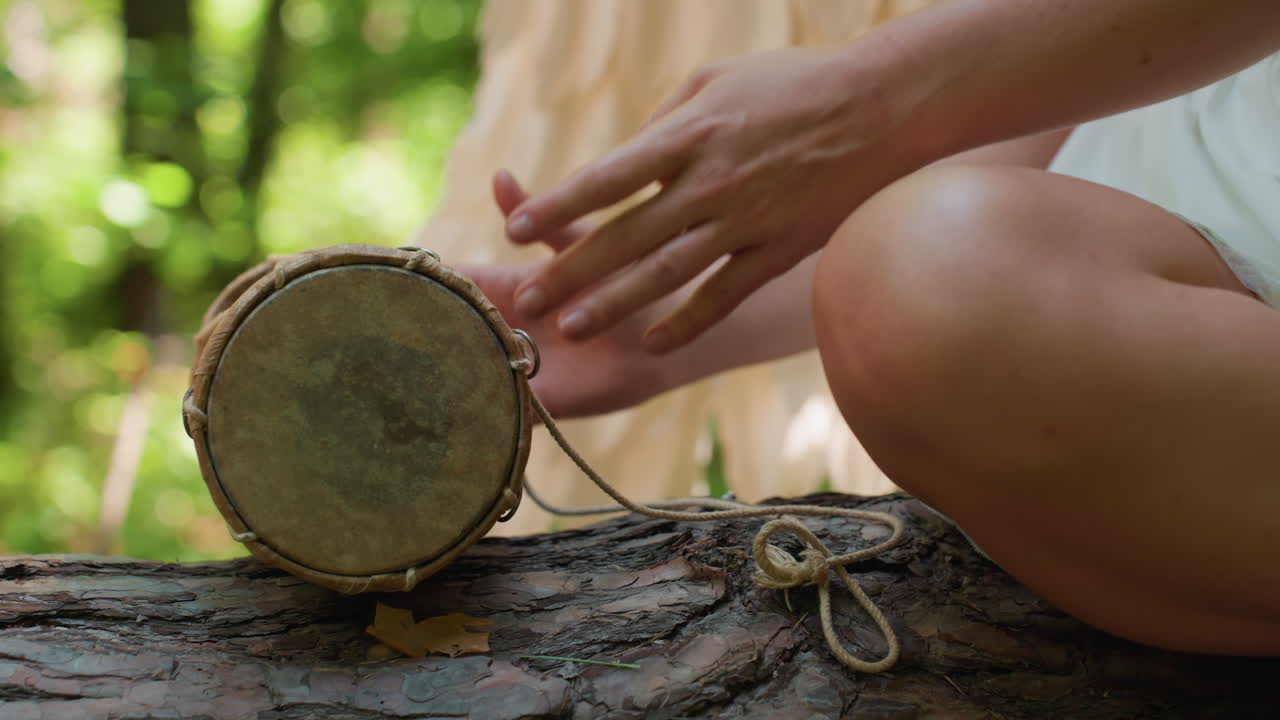 Close up of fairy woman gracefully dropping small drum on forest log, sunlight glimmering through soft wings, evoking ethereal calm, harmony, and mystical connection between rhythm