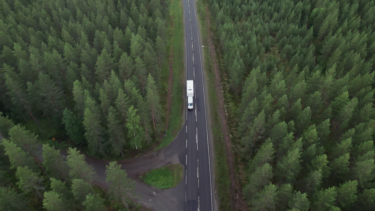 Aerial Bird View of Forest Road in Finland, White Truck Passing By, Traffic, Summer, Overcast Day