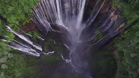 Breathtaking-tiered-Thousand-Waterfalls-Tumpak-Sewu-in-East-Java,-aerial