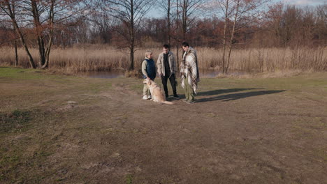 familia caminando con el perro por el río