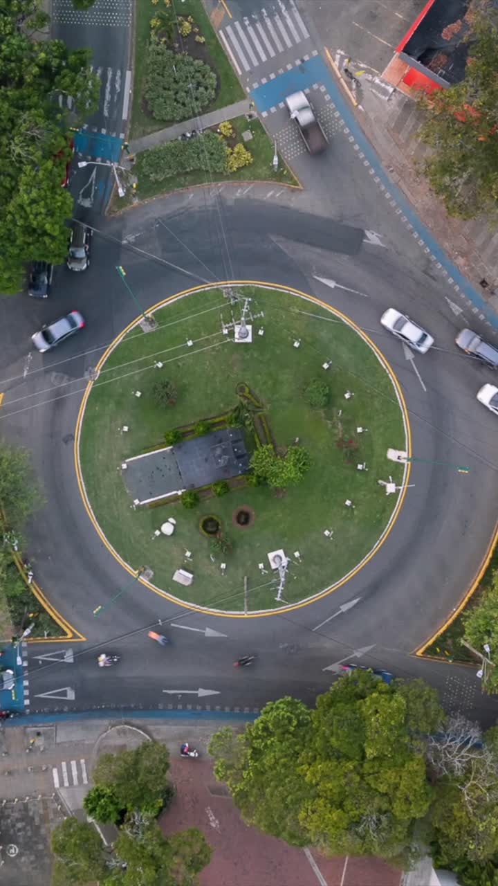 Aerial Ascending Hyperlapse of Roundabout Traffic at Ciudad Jardin. Cali, Colombia. Vertical