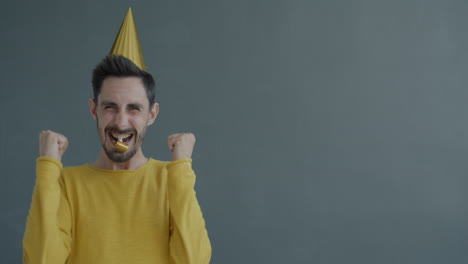 Man Celebrating with Party Hat and Whistle