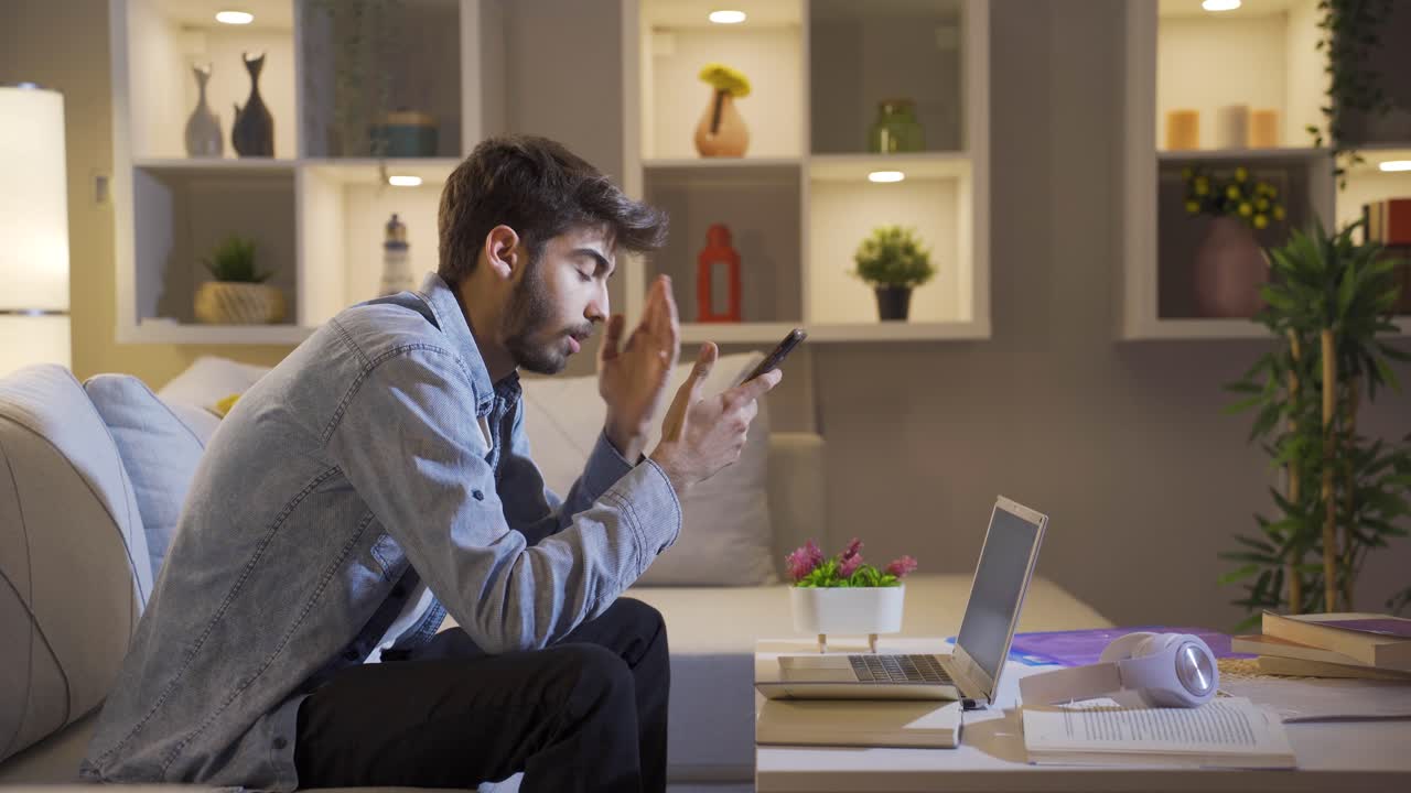 hombre deprimido en la noche enviando mensajes de texto por teléfono.