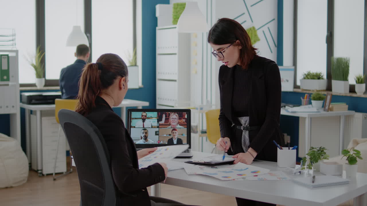 Women talking to workmates on video call for briefing meeting