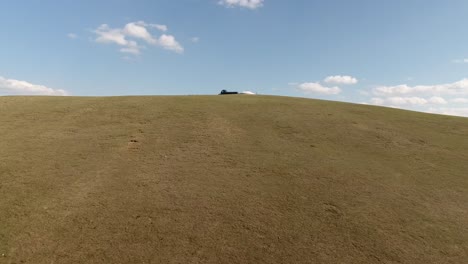 Beautiful-drone-shot-of-a-yurt-on-a-hill-discovering-mine-in-Mongolia