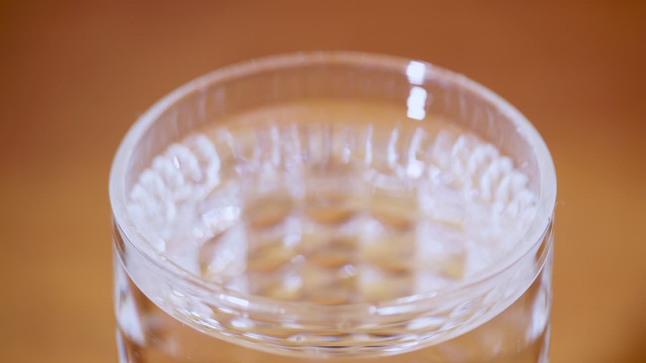 A close-up view of water being poured into a glass emphasizing hydration and refreshment a kitchen setting