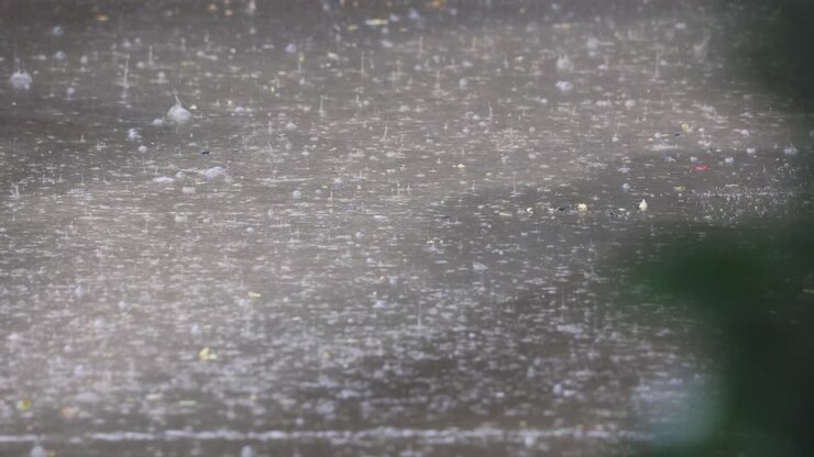 Rain Falling On The Ground With Puddles