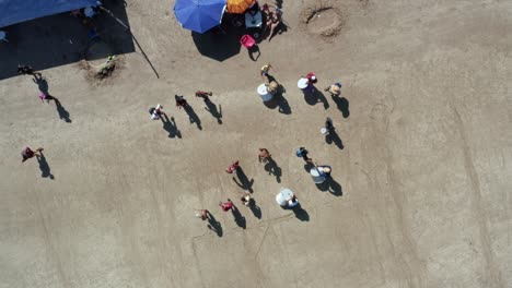 vista de pájaro que se levanta con un dron aéreo de una banda de música y adolescentes vestidos como osos peludos actuando y pidiendo dinero para el carnaval en la playa tropical de bessa en joao pessoa, paraiba, brasil