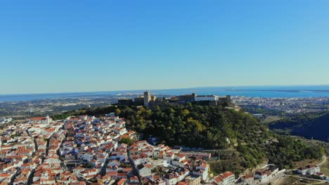 drone shot of the castle on the hill in palmela, portugal