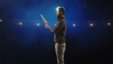 actor reading script on stage