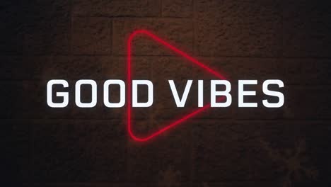 animation of good vibes text banner over neon play icon against red brick wall background