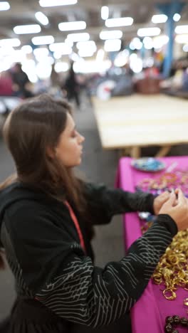 woman selling jewelry at a market