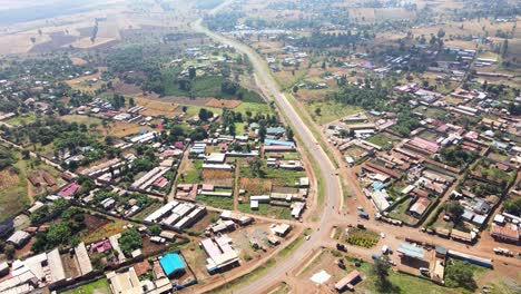 Aerial-view-of-cars-and-people-at-a-Open-Air-Market,-in-Africa---reverse,-drone-shot