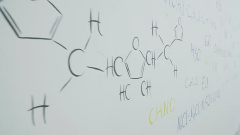 chemistry equations on a whiteboard