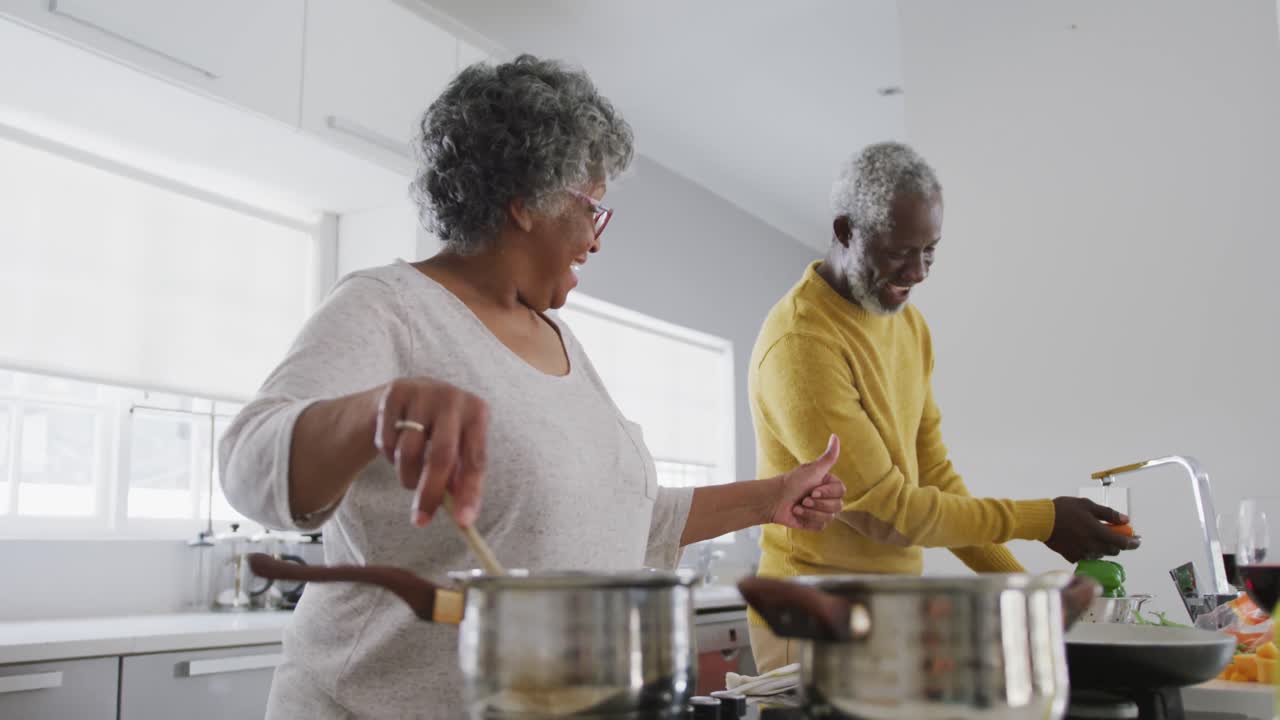 A senior African american couple cooking at home. Social distancing in quarantine